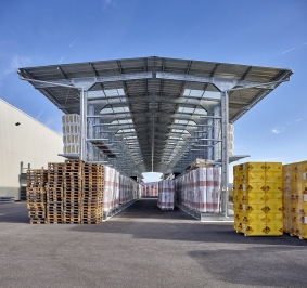 Przechowywanie materiałów na zewnątrz na 2 dwustronnych regałach wspornikowych wyposażonych w zadaszenia
			